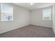 This bedroom features neutral paint, plush carpet, and large windows at 6935 Melody Ridge Rd, Buford, GA 30518
