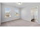 Sunlit bedroom with a light neutral carpet and trim, featuring a view through the window at 6935 Melody Ridge Rd, Buford, GA 30518