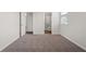 Large bedroom with neutral paint, plush carpet, with access to the bathroom at 6935 Melody Ridge Rd, Buford, GA 30518