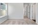 Bright bedroom with plush carpeting, a large window, and white trim throughout at 6935 Melody Ridge Rd, Buford, GA 30518