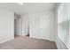 A spacious bedroom offers plush carpeting, and two bright white doors at 6935 Melody Ridge Rd, Buford, GA 30518