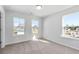 Inviting bedroom with neutral carpet, and three large windows offering ample natural light at 6935 Melody Ridge Rd, Buford, GA 30518