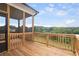 View of a spacious, screened deck featuring natural wood and a scenic view of the surrounding landscape at 6935 Melody Ridge Rd, Buford, GA 30518
