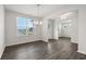 Formal dining room with a chandelier and lots of natural light from the large window at 6935 Melody Ridge Rd, Buford, GA 30518