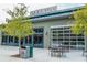 Modern commercial building featuring Halcyon signage, sleek design, outdoor seating, and ample natural light at 6935 Melody Ridge Rd, Buford, GA 30518