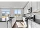 Stylish kitchen featuring stainless steel appliances, granite countertops, and a breakfast bar at 6935 Melody Ridge Rd, Buford, GA 30518