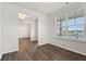 Open-concept area with hardwood flooring, large window and views to the dining room at 6935 Melody Ridge Rd, Buford, GA 30518