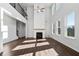 Inviting living room featuring high ceilings, a modern fireplace, and plenty of natural light at 6935 Melody Ridge Rd, Buford, GA 30518