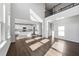 Open concept living room with high ceilings, kitchen view, and dark wood flooring at 6935 Melody Ridge Rd, Buford, GA 30518