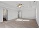 Spacious main bedroom with carpeted floors, tray ceiling, and ample natural light at 6935 Melody Ridge Rd, Buford, GA 30518