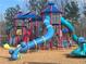 A colorful playground with slides and climbing structures amidst a wood chip ground cover, perfect for Gathering fun at 6935 Melody Ridge Rd, Buford, GA 30518