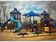 Community playground has multiple slides, towers, and play structures with a wood chip base at 6935 Melody Ridge Rd, Buford, GA 30518
