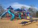 The vibrant community playground has multiple slides, towers, and play structures for children of all ages at 6935 Melody Ridge Rd, Buford, GA 30518