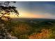 Sweeping scenic vista with a vibrant sunset over rolling hills, forests and distant fields at 6935 Melody Ridge Rd, Buford, GA 30518