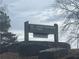 Lower Pool West Park sign surrounded by rocks offering tranquil outdoor community space at 6935 Melody Ridge Rd, Buford, GA 30518
