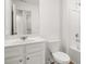 Bright bathroom featuring single sink vanity, framed mirror, and combination bathtub and shower at 205 Kenoot Dr # 55, Mcdonough, GA 30253