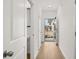 Bright hallway with wood-look floors, leading to front door and living areas at 205 Kenoot Dr # 55, Mcdonough, GA 30253