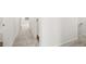 Bright hallway featuring neutral walls and carpet, with white doors and trim at 205 Kenoot Dr # 55, Mcdonough, GA 30253