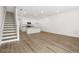Open living space with staircase, modern kitchen, and wood-look floors at 205 Kenoot Dr # 55, Mcdonough, GA 30253