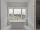 Bright bathroom featuring a freestanding tub and a large window providing natural light at 357 Mell Ne Ave, Atlanta, GA 30307