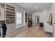 Spacious walk-in closet with custom shelving, drawers, seating area and wood floors at 357 Mell Ne Ave, Atlanta, GA 30307