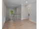 Upstairs hallway featuring hardwood floors, crown molding, and natural light from the window at 357 Mell Ne Ave, Atlanta, GA 30307