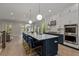 Modern kitchen with white cabinets, stainless steel appliances, island with bar seating and open to the dining area at 357 Mell Ne Ave, Atlanta, GA 30307