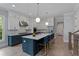 Modern kitchen with a large island with seating, two-tone cabinets and stainless steel appliances at 357 Mell Ne Ave, Atlanta, GA 30307