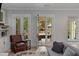 Well-lit living room with a comfortable armchair and view to the porch at 357 Mell Ne Ave, Atlanta, GA 30307