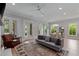 Bright living room features hardwood floors, a comfortable grey couch and French doors leading to the outside at 357 Mell Ne Ave, Atlanta, GA 30307