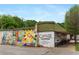 Exterior view of Candler Park Market with colorful mural and outdoor seating at 357 Mell Ne Ave, Atlanta, GA 30307