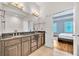 Bathroom with double sinks, vanity, and access to the main bedroom at 3676 Brookhaven Manor Ne Xing, Atlanta, GA 30319
