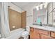 Cozy bathroom featuring a shower-tub combination with tiled surround, granite countertop, and wood vanity at 3676 Brookhaven Manor Ne Xing, Atlanta, GA 30319