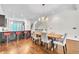 Dining area featuring hardwood floors, a chandelier, and breakfast bar with stools, perfect for entertaining at 3676 Brookhaven Manor Ne Xing, Atlanta, GA 30319