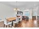 Dining area featuring hardwood floors and a chandelier, with a kitchen and stairway in the background at 3676 Brookhaven Manor Ne Xing, Atlanta, GA 30319