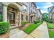 Attractive stone and brick townhome with well-manicured landscaping and sidewalk at 3676 Brookhaven Manor Ne Xing, Atlanta, GA 30319