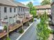 Brick townhome with upper-level deck and lower-level car port, as well as verdant landscaping at 3676 Brookhaven Manor Ne Xing, Atlanta, GA 30319