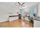 Well-lit home office featuring built-in desks, storage, hardwood floors and ceiling fan at 3676 Brookhaven Manor Ne Xing, Atlanta, GA 30319