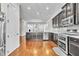 Spacious kitchen features stainless steel appliances, custom cabinets, granite countertops and mosaic backsplash at 3676 Brookhaven Manor Ne Xing, Atlanta, GA 30319