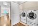 Laundry room equipped with washer and dryer and storage shelves at 3676 Brookhaven Manor Ne Xing, Atlanta, GA 30319