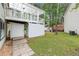 Backyard with a covered deck, white siding, and a well-maintained lawn, with stone walkway at 4258 Anderson Ridge Way, Austell, GA 30106