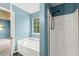 Bathroom featuring a large tub under a window and a shower at 4258 Anderson Ridge Way, Austell, GA 30106