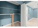 Laundry room with blue walls, white shelving, and tile floor at 4258 Anderson Ridge Way, Austell, GA 30106