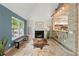Bright living room featuring stone archway, fireplace, and tiled floors at 4258 Anderson Ridge Way, Austell, GA 30106