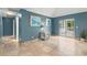 Open living room with tile flooring leading to screened patio with bright blue walls at 4258 Anderson Ridge Way, Austell, GA 30106