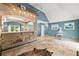 Open living room with stone bar area, tile floors, and bright blue walls at 4258 Anderson Ridge Way, Austell, GA 30106