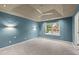 Spacious main bedroom featuring tray ceilings, modern lighting, and a large window at 4258 Anderson Ridge Way, Austell, GA 30106