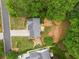 Aerial perspective showcasing the home, deck, landscaping, and surrounding neighborhood at 5525 Tallantworth Trl, Cumming, GA 30040