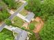 An aerial view of a charming home with a well-manicured lawn and beautiful landscaping at 5525 Tallantworth Trl, Cumming, GA 30040