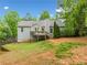 Back exterior view of home with deck, backyard, siding, and green landscaping at 5525 Tallantworth Trl, Cumming, GA 30040